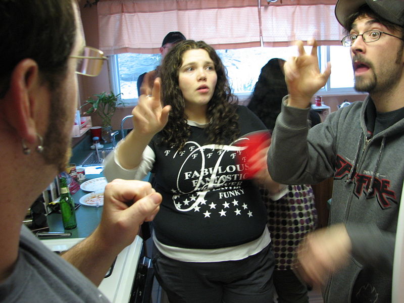 Group of people communicating through sign language