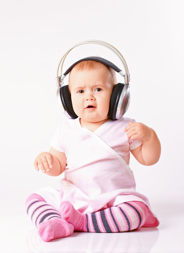 a baby girl wearing a headset