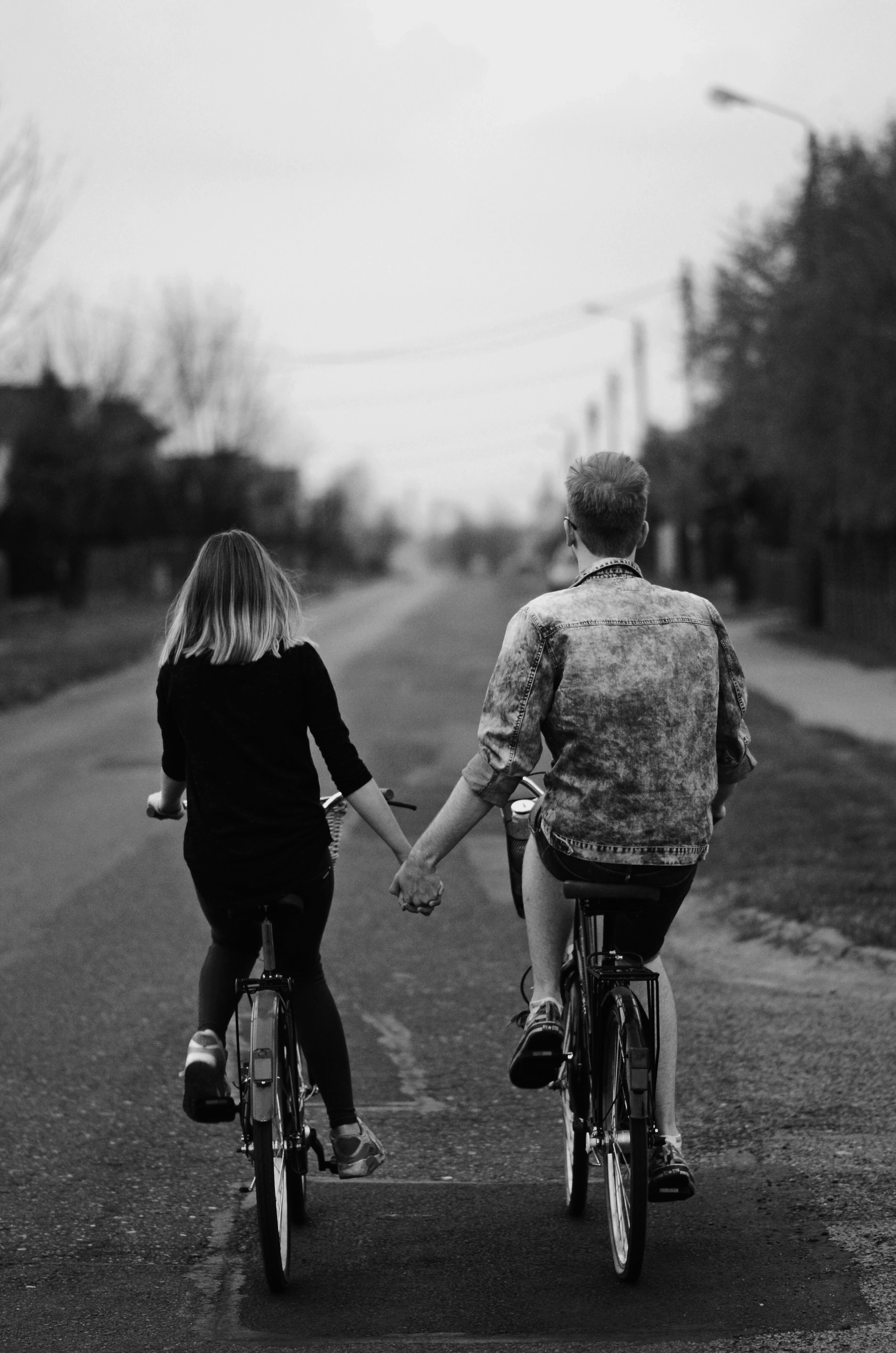 A couple riding on bikes together